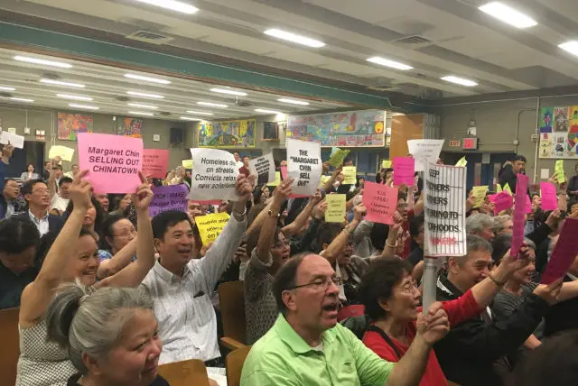 Chinatown residents booed and jeered as city officials tried unsuccessfully to lay out their plans for a new jail